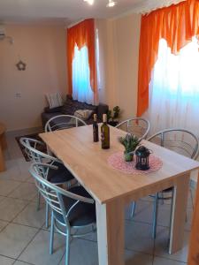 a dining room table with chairs and a couch at Apartman Sanjković in Rovinjsko Selo