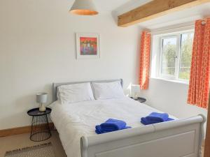 a bedroom with a bed with blue towels on it at Valley View in St Austell