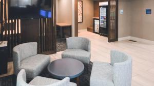 a waiting room with two chairs and a table and a tv at Holiday Inn Express Lompoc, an IHG Hotel in Lompoc