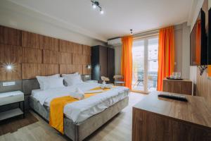a bedroom with a large bed with orange curtains at Villa Darki in Ohrid