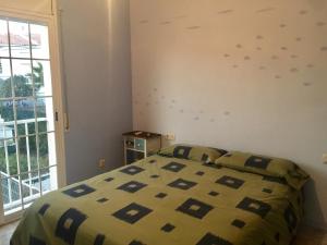 a bedroom with a bed and a window at Torredembarra House in Torredembarra