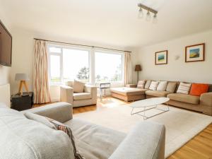 a living room with a couch and a table at Seaport Lodge in Mawgan Porth