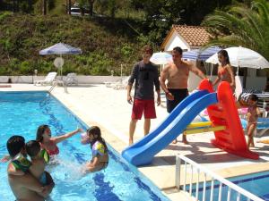 a group of people playing in a swimming pool at Alessandro in Sidari