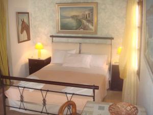 a bedroom with a bed and a picture on the wall at Alessandro in Sidari