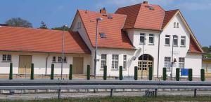 a house with red roofs and a fence in front of it at Holiday Home Uckeritz - Seebad 1 in Ueckeritz +16 photos
