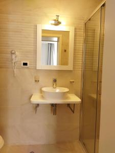 a bathroom with a sink and a shower at Hotel House K21 in Sofia