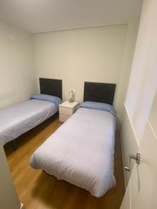 A bed or beds in a room at Piso Lectra 2 Még 7 kép