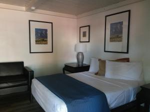 a hotel room with a bed and a painting on the wall at Sterling Gardens in Las Vegas
