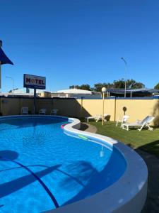 a swimming pool with a blue sky at Sunburst Motel in Gold Coast