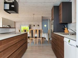 a kitchen with a table and a dining room at 8 person holiday home in Hejls in Hejls