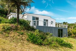 a white house on top of a hill at Roses Bach in Onetangi