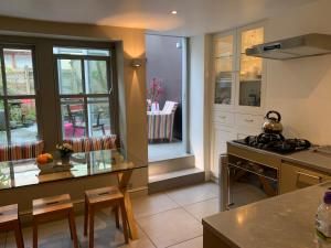 a kitchen with a stove and a counter top at South Lakes Townhouse with Sauna in Ulverston