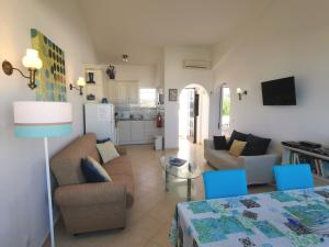 a living room with a couch and a table at Favorite at Senhora da Rocha in Porches