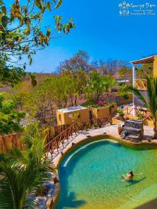 a person in the water in a swimming pool at Carpe Diem Casitas & Villas Mazunte in Mazunte