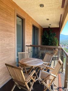 a patio with a table and chairs on a balcony at Dreamland deluxe apartment in Chakvi