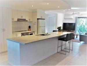 a kitchen with a large island in the middle at Outrigger Bay in Byron Bay