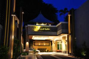 a car parked in front of a building at night at August Suites in Pattaya Central