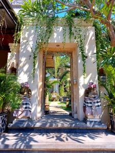 an open door to a house with plants at Sama Sama Amed in Amed