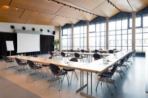 ein großer Konferenzraum mit einem großen Tisch und Stühlen in der Unterkunft Hotel am Stadtpark in Borken