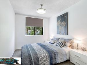 A bed or beds in a room at The Nest At Fingal Bay