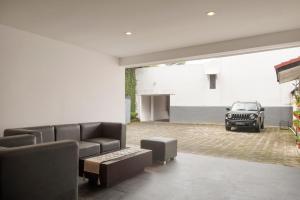 a living room with a couch and a car in a garage at Lembang Views in Lembang