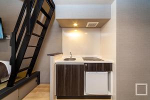 Postel nebo postele na pokoji v ubytování HOTEL SUITE HIROSHIMA YOKOGAWA