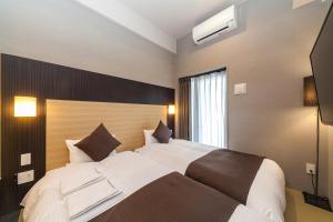 Postel nebo postele na pokoji v ubytování HOTEL SUITE HIROSHIMA YOKOGAWA