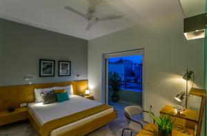 a bedroom with a large bed and a balcony at Koukounari Living Spaces in Preveza