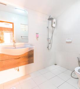 a bathroom with a sink and a mirror at MANDARIN LODGE by victor in Hua Hin