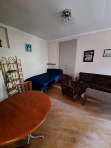 a living room with a couch and a table at center LG Apartment in Tbilisi City