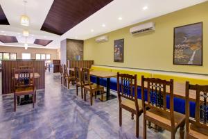 a dining room with wooden tables and chairs at Club Mahindra Netrang in Netrang