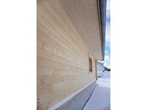 ein Holzgebäude mit Schnee an der Seite in der Unterkunft Ferientraum Teufel in Hettingen