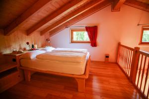 a bedroom with a large bed in a attic at Agritur Dal Fior La Casa nel Bosco in Roncegno