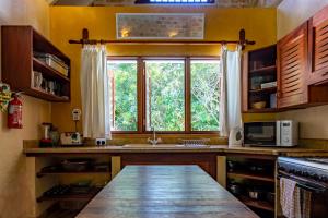 a kitchen with a large window and a sink at private pool cottage diani beach in Diani Beach