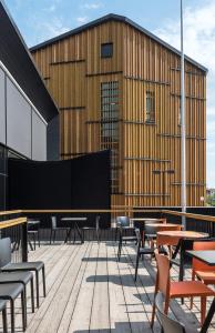 a building with tables and chairs on a patio at Park Hotel Liminka in Liminka