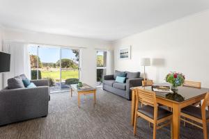 a living room with a couch and a table at Quest Williamstown North in Williamstown
