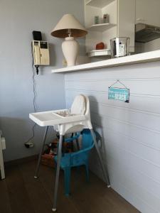 a table and a chair in a room at Appartement Residentie Amadeus met garage-lift in Sint-Idesbald