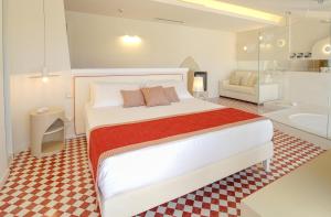 a bedroom with a large bed and a bathroom at Suite Hotel L'Oasi di Riaci in Santa Domenica