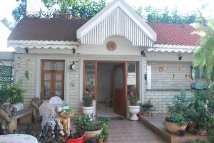 a small white house with plants in front of it at Terrace Gardens in Bangalore