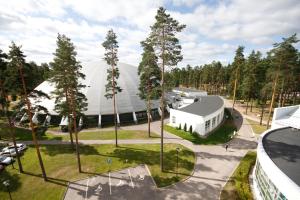 an aerial view of a large white building with trees at Hotelli Fennada in Vierumäki