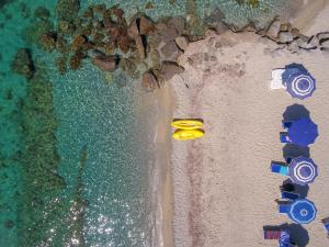 an overhead view of a beach with two yellow objects at Suite Hotel L'Oasi di Riaci in Santa Domenica