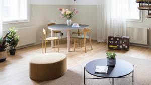 a living room with a round table and chairs at Bob W Helsinki City Centre in Helsinki