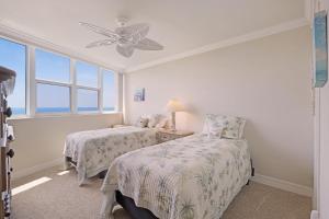 a bedroom with two beds and a window at Gorgeous beachfront condo with SW-facing balcony in Marco Island +23 photos