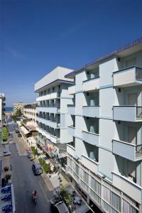 an apartment building with balconies on a city street at Hotel Elite Cattolica in Cattolica