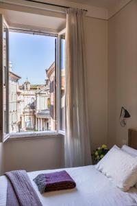 a bedroom with a bed and a large window at MyNavona in Rome