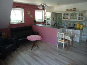 a kitchen with a black couch and a pink table at Ferienwohnung Altstadt-Insel Rathenow in Rathenow +15 photos
