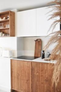 a kitchen with wooden cabinets and a counter top at Apartment WABI-SABI by JAPANDI home in Megève +13 photos