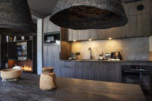 a kitchen with a wooden table with a vase on it at Apartment FERRONNE by JAPANDI home in Megève
