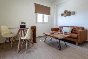 a living room with a couch and a table at Remezzo Aqua Blue Maisonette in Livadi Astypalaias