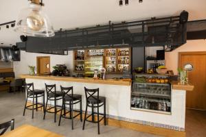 a bar in a restaurant with black stools at Hotel Chrobrego9 in Bolesławiec